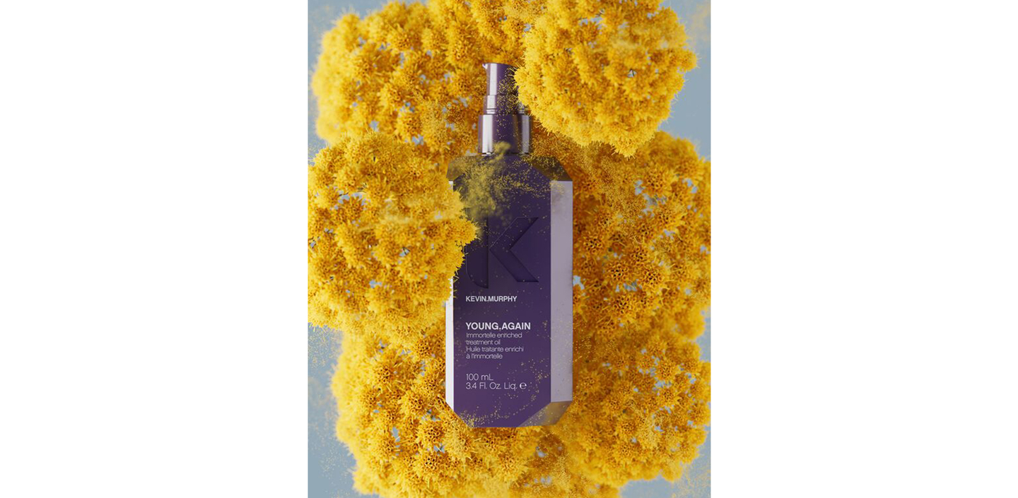 YOUNG.AGAIN oil bottle surrounded by yellow flowers with powder effect